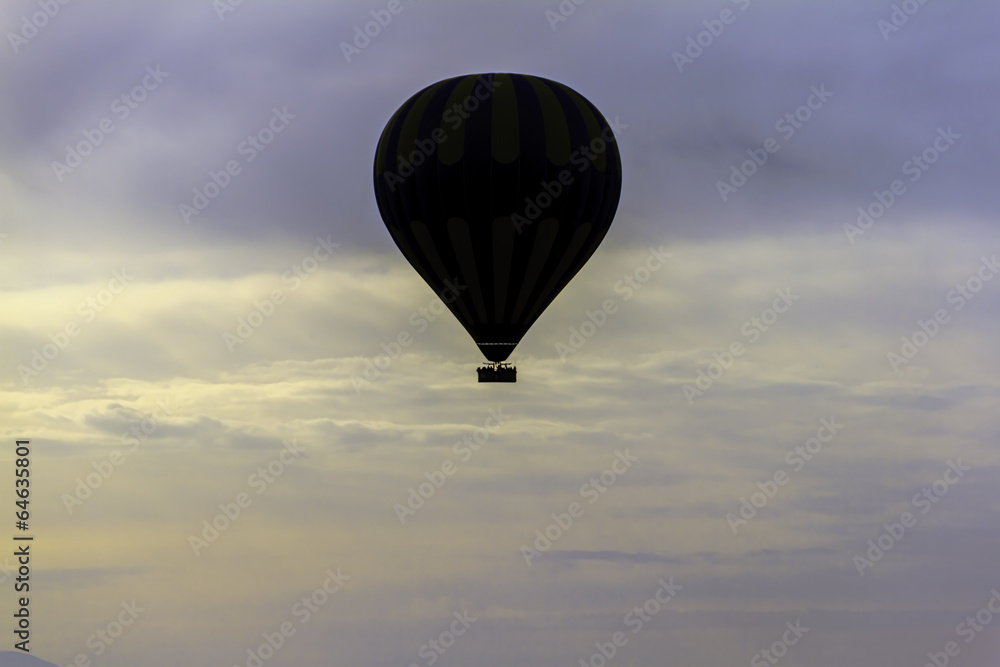 Fototapeta Hot Air balloon flying over the clouds