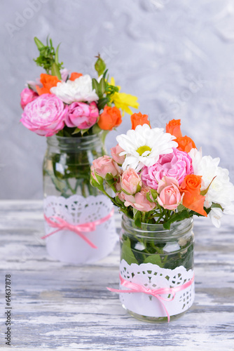 Fototapeta Naklejka Na Ścianę i Meble -  Beautiful bouquet of bright flowers in jars