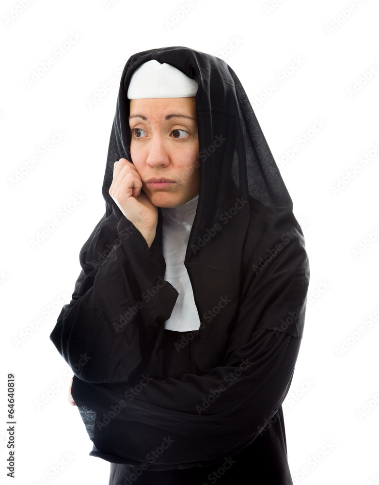Young nun looking sad with her hand on chin Young nun looking sad with her hand on chin