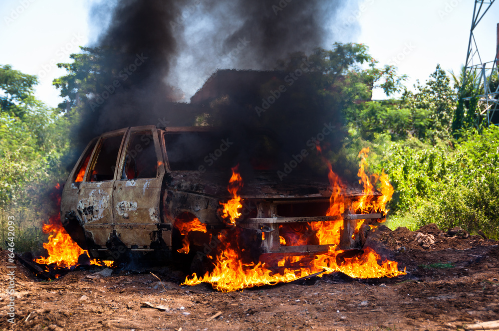 Fototapeta premium Burning Car in the Field