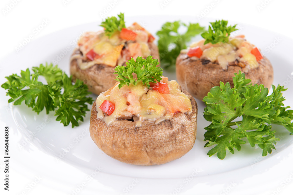 Stuffed mushrooms on plate isolated on white Stuffed mushrooms on plate isolated on white
