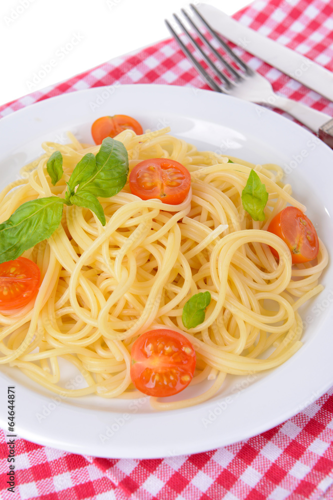 Delicious spaghetti with tomatoes on plate on table close-up Delicious spaghetti with tomatoes on plate on table close-up