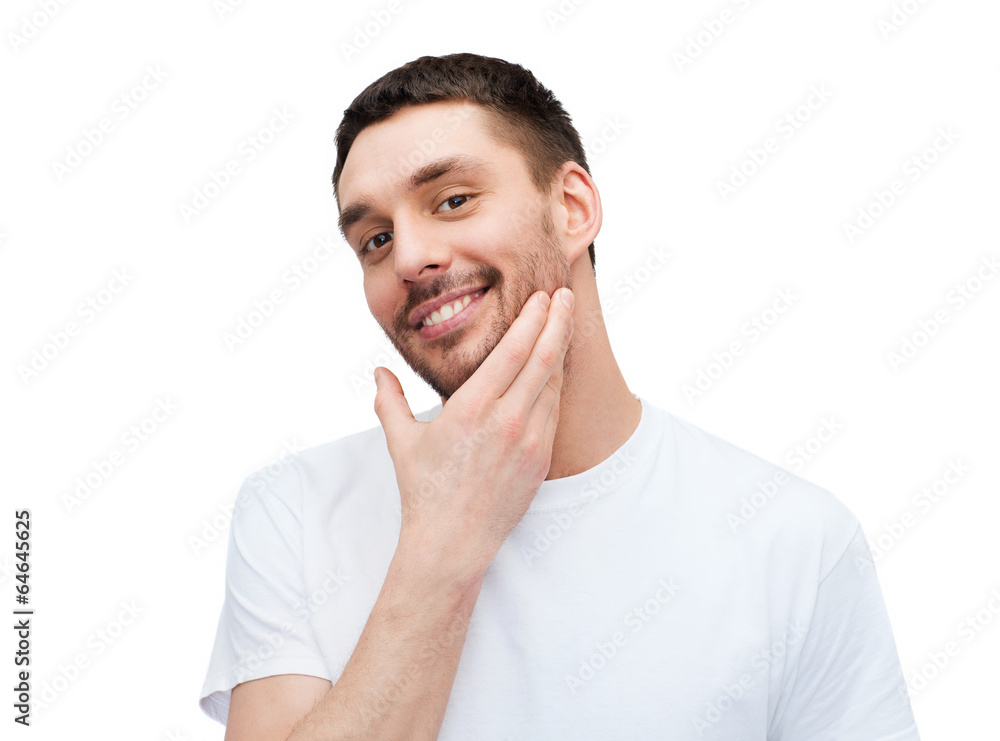 beautiful smiling man touching his face beautiful smiling man touching his face