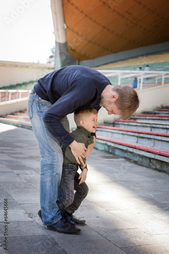 Father and son playing in empty stadium