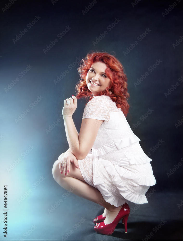 Romantic redhead woman posing.