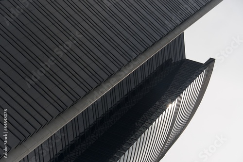 Curved sunlit facade of Hong Kong skyscraper