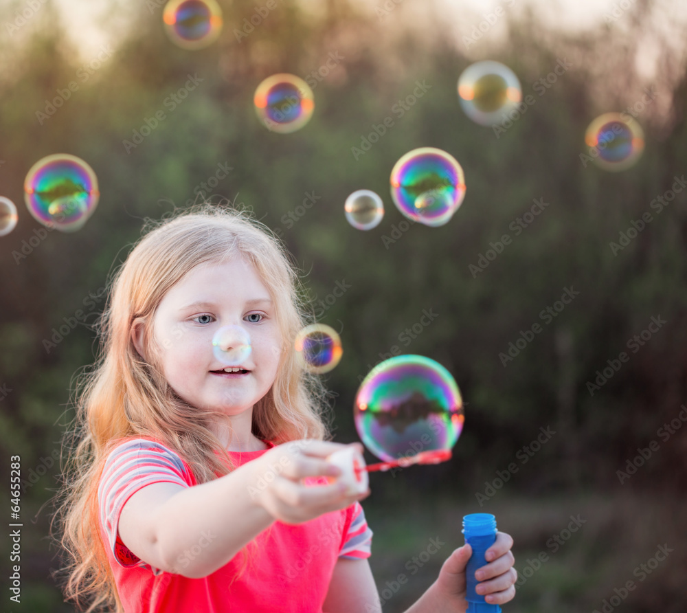 girl blowing soap bubbles outdoor at sunset girl blowing soap bubbles outdoor at sunset