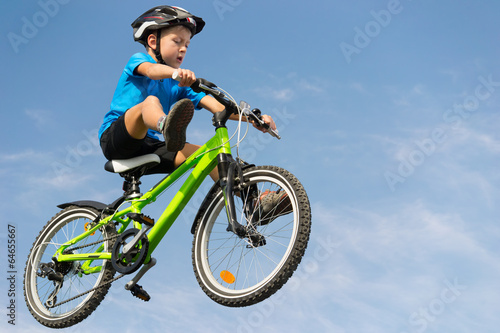 Boy jumping on bike