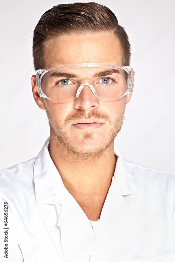 Portait of young male lab assistant with protective glasses