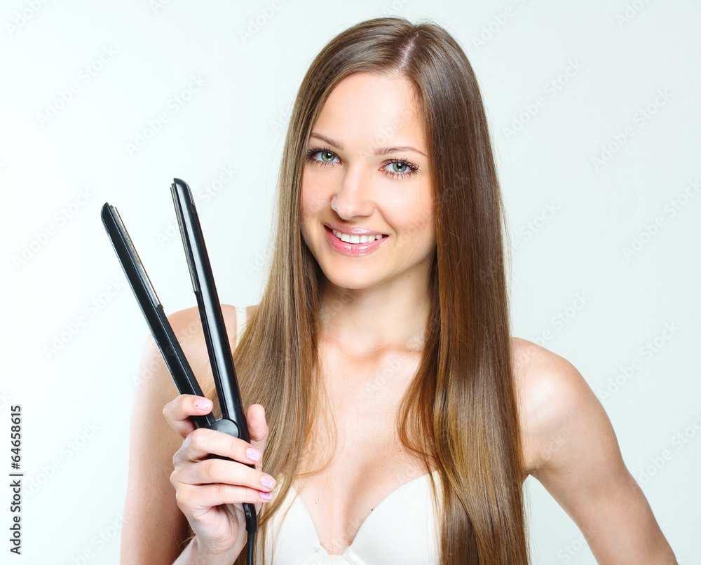 woman styling her long natural hair. straight hair. woman styling her long natural hair. straight hair.
