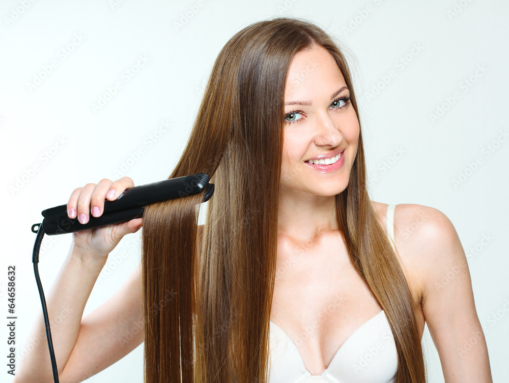 woman styling her long natural hair. straight hair. woman styling her long natural hair. straight hair.