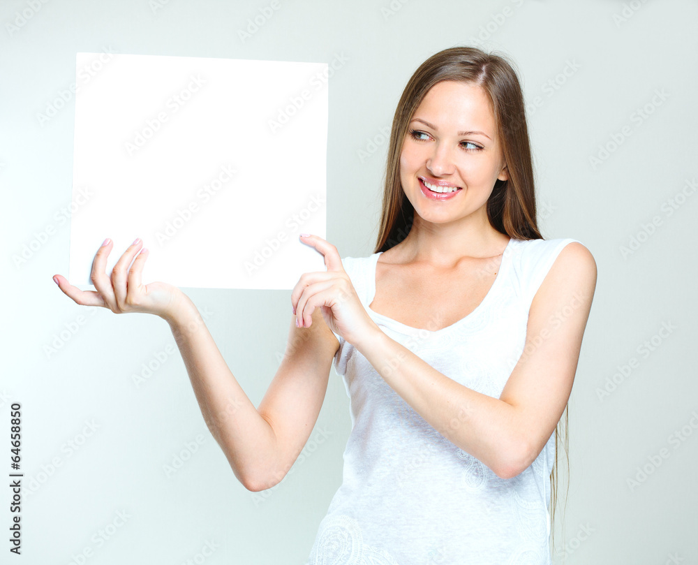young smiling woman holding blank card young smiling woman holding blank card