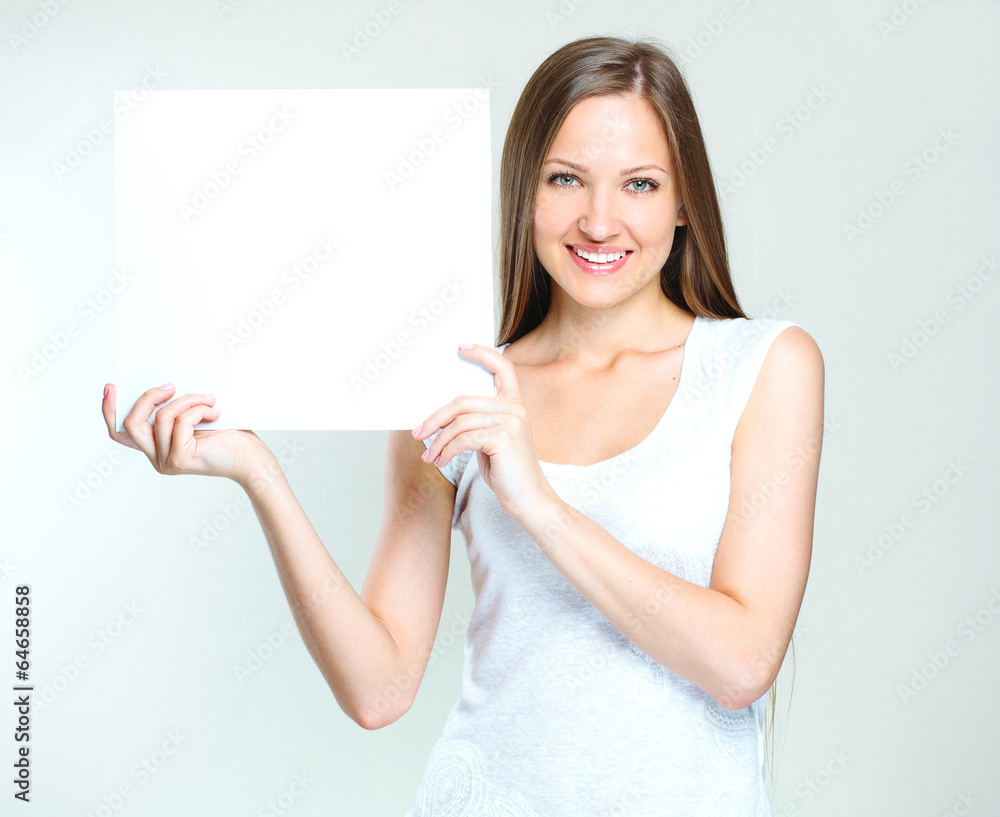 young smiling woman holding blank card young smiling woman holding blank card