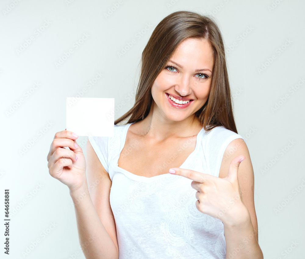young smiling woman holding blank card young smiling woman holding blank card