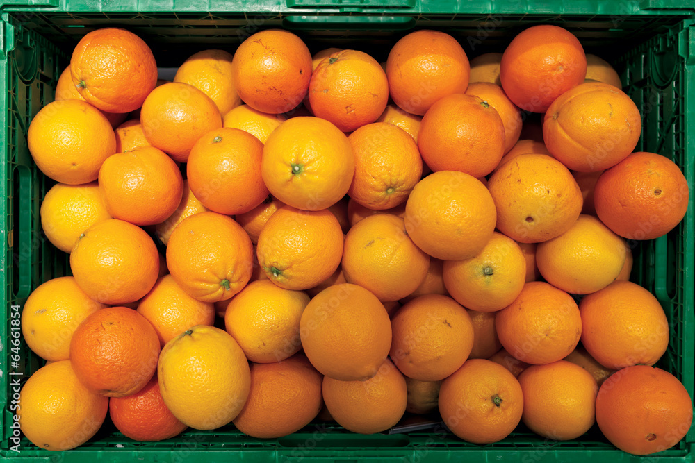 Green crate full of oranges Green crate full of oranges