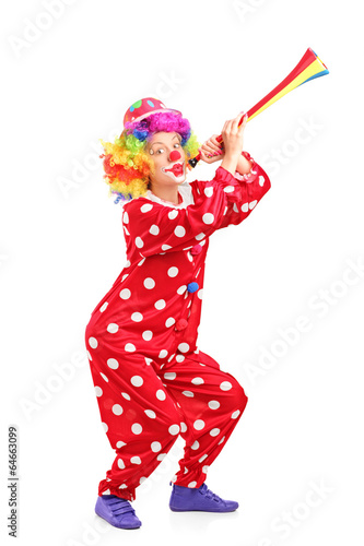 Female clown blowing a horn