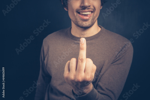 Obraz na plátně Young man displaying obscene gesture