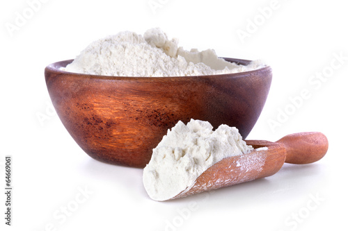 flour in a wooden bowl and shovel on a white background photo