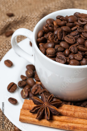 Coffee beans and coffee cup close-up vertical