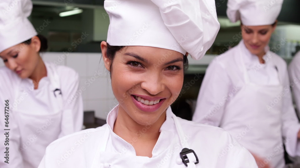 Smiling chef whisking eggs in a bowl Smiling chef whisking eggs in a bowl