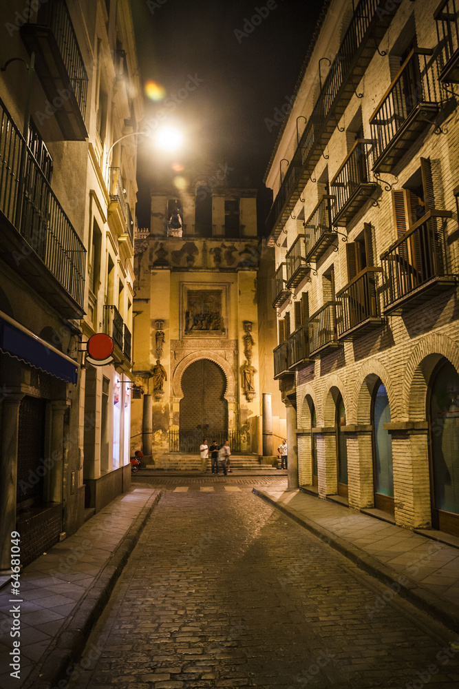 Narrow street in Seville at night, Spain