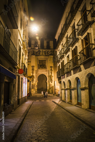 Narrow street in Seville at night, Spain