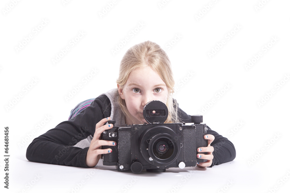 young girl with large old fashioned camera in studio young girl with large old fashioned camera in studio