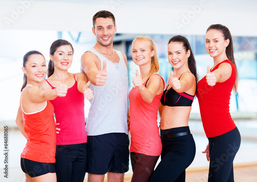group of people in the gym showing thumbs up