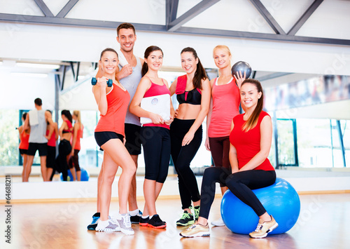 group of smiling people in the gym