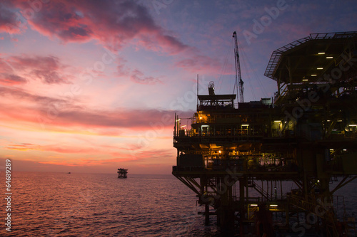 Silhouette of an offshore oil rig at sunset