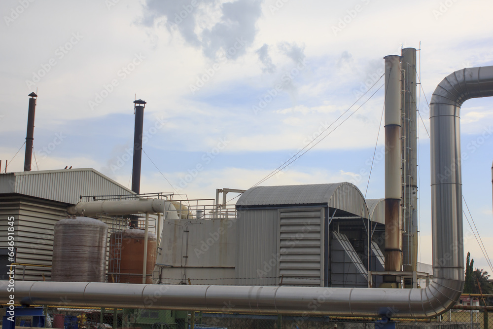 Industrial zone, Steel pipelines and valves against blue sky Industrial zone, Steel pipelines and valves against blue sky