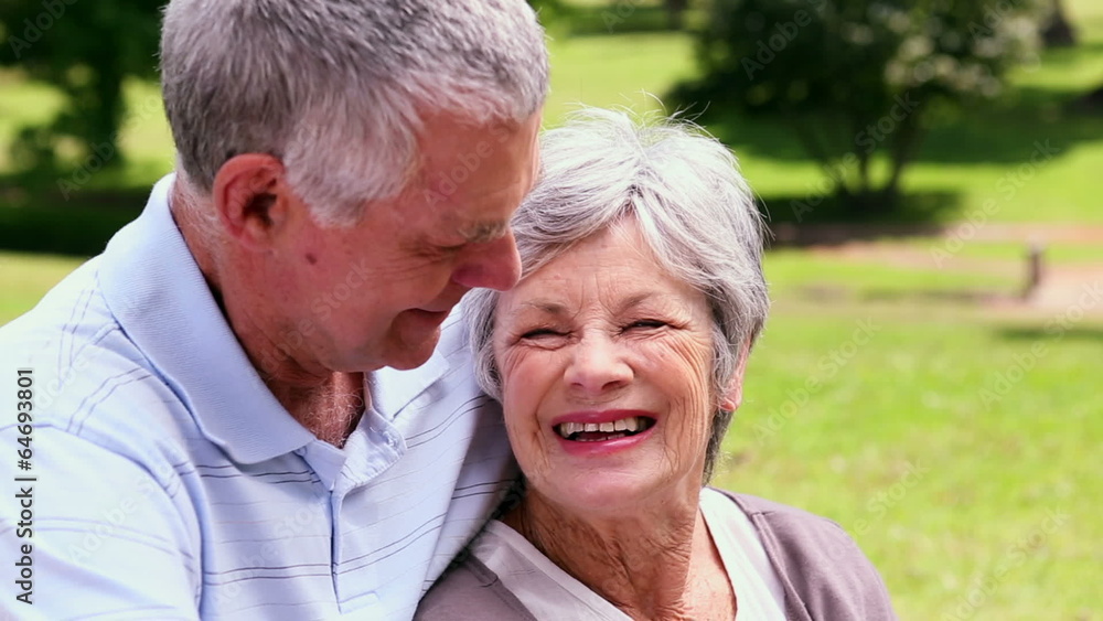 Senior couple relaxing in the park together Senior couple relaxing in the park together