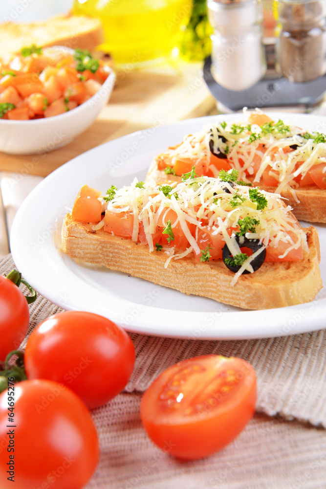 Delicious bruschetta with tomatoes on plate on table close-up Delicious bruschetta with tomatoes on plate on table close-up