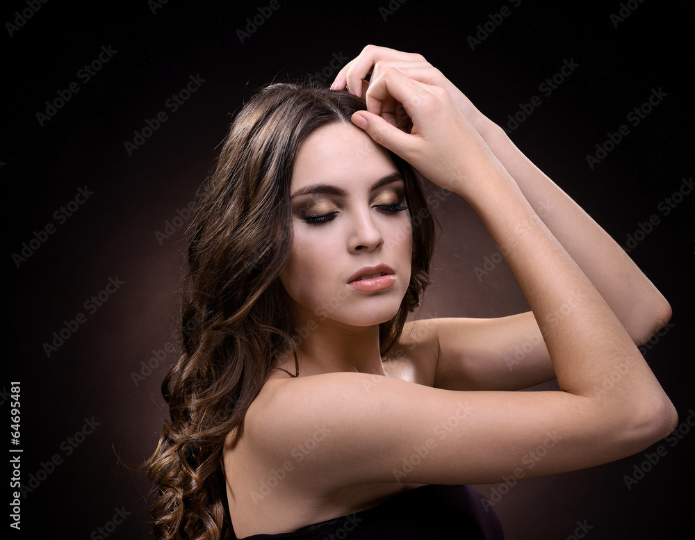 Beautiful young woman with long hair on dark brown background Beautiful young woman with long hair on dark brown background