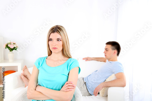 Portrait of young man and woman conflict sitting