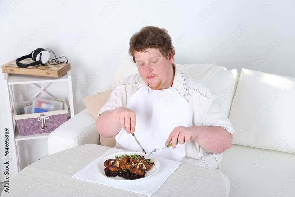 Tasty lunch for fat man, on home interior background Tasty lunch for fat man, on home interior background
