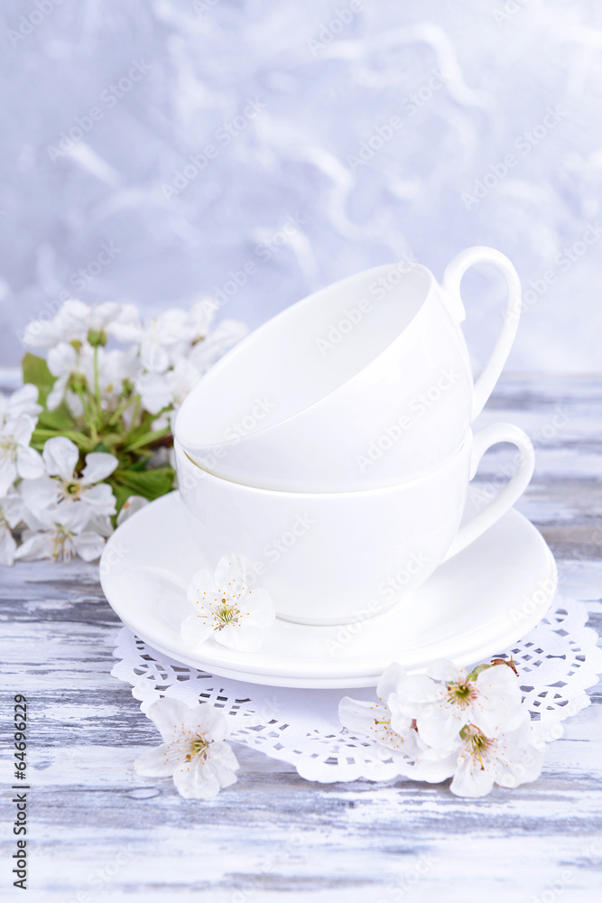 Beautiful fruit blossom in glass on table on grey background Beautiful fruit blossom in glass on table on grey background