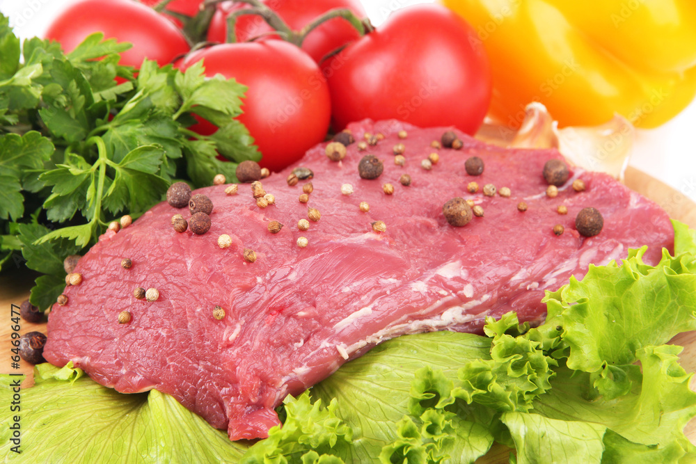 Raw beef meat with spices and vegetables close up Raw beef meat with spices and vegetables close up