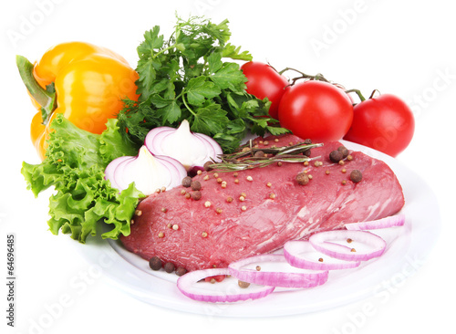 Raw beef meat with vegetables on plate isolated on white