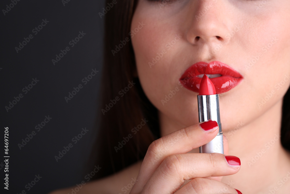 Girl with sexy red lips and pomade on dark background Girl with sexy red lips and pomade on dark background