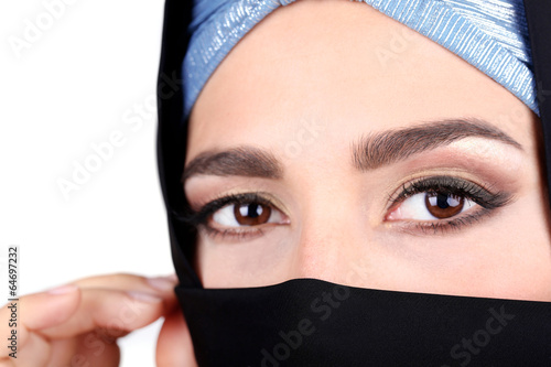 Beautiful muslim arabic woman in paranja on grey background photo