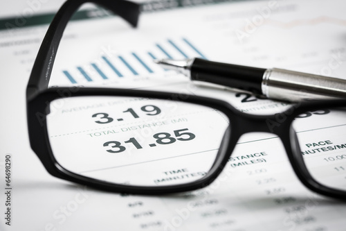 closeup glasses on financial report