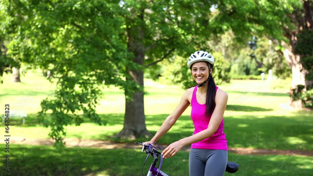 Fit girl going for a bike ride in the park Fit girl going for a bike ride in the park