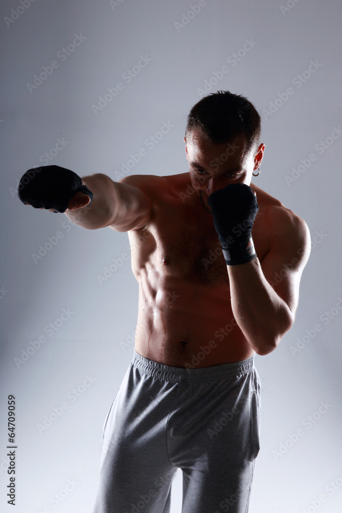 Portrait of a sportsman boxing on gray background Portrait of a sportsman boxing on gray background