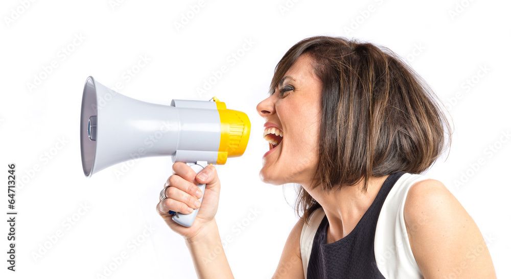 Naklejka premium Pretty girl shouting with a megaphone over white background