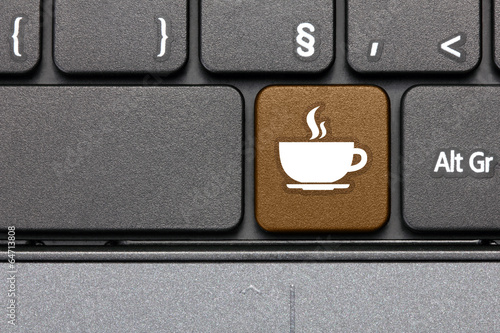 Coffee break. Brown hot key on computer keyboard. photo