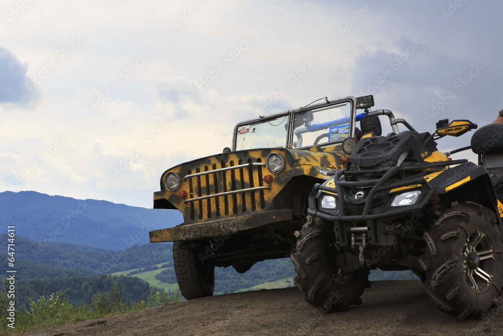 Fototapeta premium Dirty SUV and the vehicle on top of the mountain.