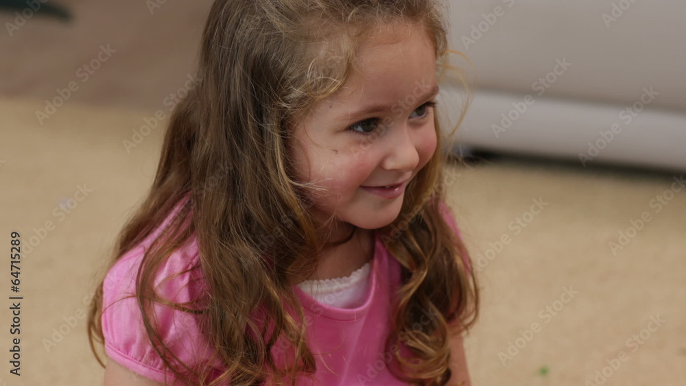 Little girl sitting on the floor smiling Little girl sitting on the floor smiling