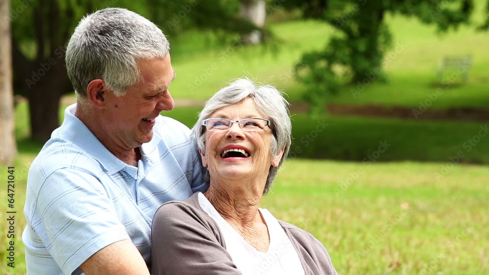 Affectionate senior couple relaxing in the park Affectionate senior couple relaxing in the park