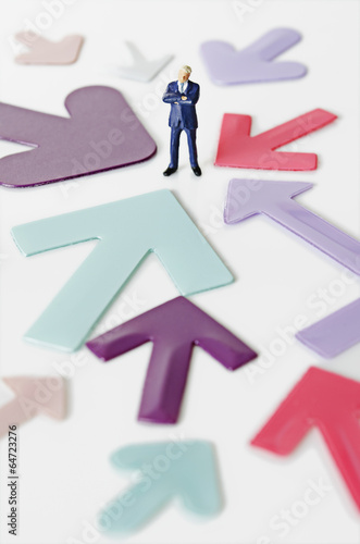 Business figurine with arrows